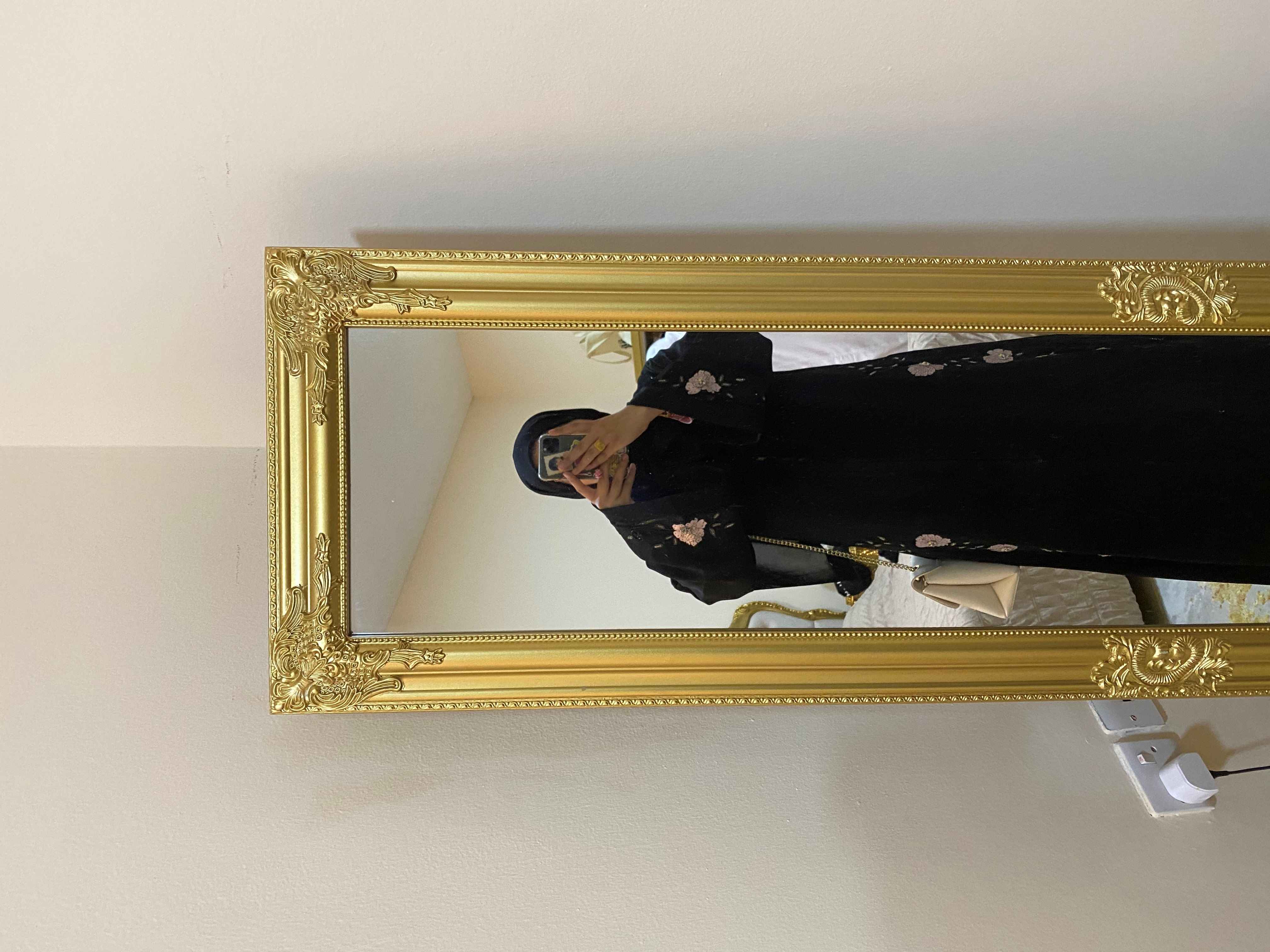 Photo of Zamzam standing in front of a mirror taking a picture of her reflection